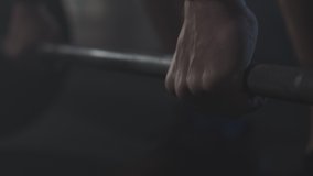 Unrecognizable sportsman taking barbell in foggy gym. Strong male hands raising hand weights. Bodybuilding, powerlifting, weightlifting, sport, healthy lifestyle. - Powered by Shutterstock - Get 15% off with code: PIKWIZARD15