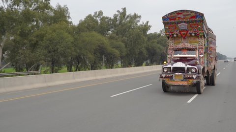 Pakistani Jingle Truck driving on a highway nearby Lahore, Pakistan