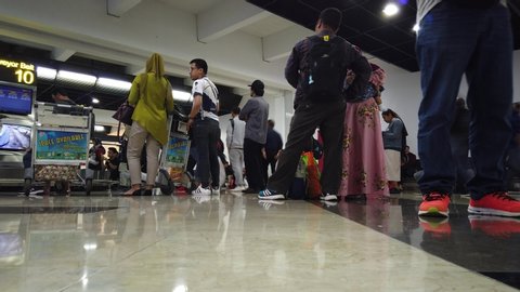 Jakarta / Indonesia - Oct 13, 2019: Established Shot of People Waiting Their Luggage at Baggage Claim Area Terminal 2 Soekarno Hatta Airport