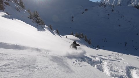 Freeride skiing in good conditions and best style. Professional offpist skiing and very smooth filming in sixty frames per second. The mountains look big and the snow is nice and cold.