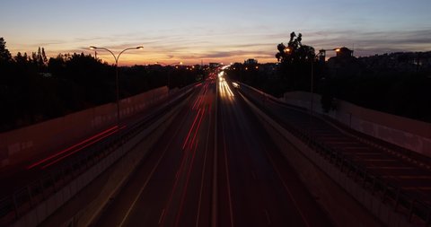 Day to night fast motion time lapse of busy urban highway during rush hour