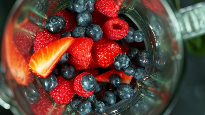 fresh fruit blended in a blender. top view. strawberry. Healthy eating concept. Super slow motion filmed on high speed cinematic camera.