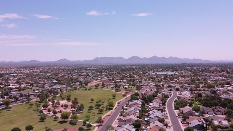 Phoenix Arizona, USA community  aerial drone view of North Phoenix  neighborhood, housing and park with Mountains in background.