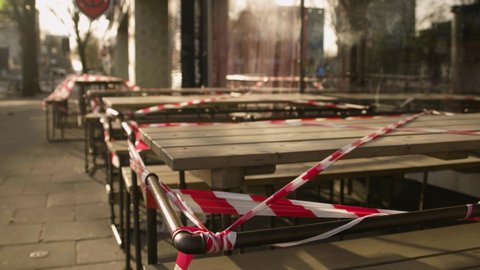 Outdoor restaurant tables with barricade tape in Hamburg Germany during the coronavirus lockdown.