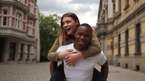 A black man and a caucasian woman have fun on a city street. Young interracial couple in love, Valentines Day, black and white couple - Powered by Shutterstock - Get 15% off with code: PIKWIZARD15