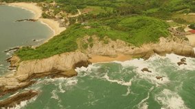 

Panoramic top view of the Pacific Ocean and its coastline on a cloudy day. Mexico. Video made by drone.