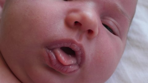 close-up macro shot baby mouth newborn lips baby brings milk back up reflux