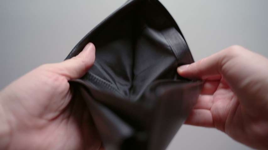 Businessman holding black leather empty wallet, no money in wallet, concept of total financial bankruptcy. Economic crisis and troubles at work, no saving cash, global unemployment | Shutterstock HD Video #1054569101