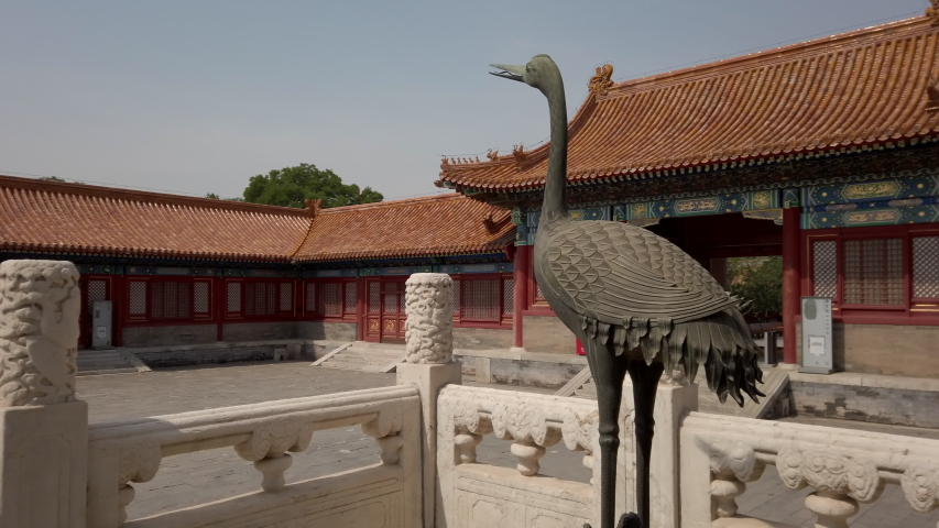 Bronze crane stands by marble column in Forbidden City, Beijing, China