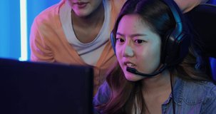 Young asian team woman gamer having live stream and playing in Online Video Game. They playing and get lose in video games on a computer.