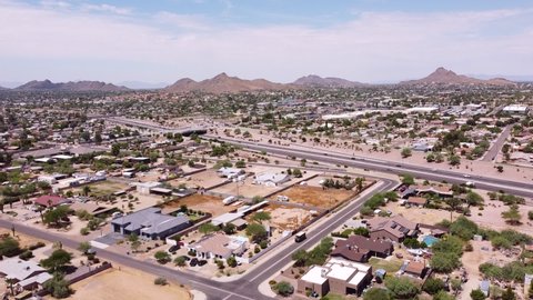 Phoenix Arizona, USA community  aerial drone view of North Phoenix  neighborhood, housing and Interstate 51, Piestewa freeway with  mountains in background