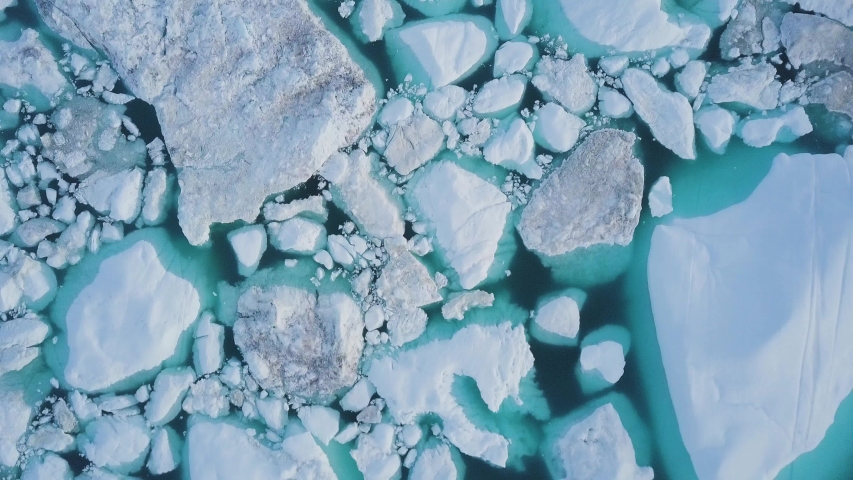 Icebergs drone aerial video top view - Climate Change and Global Warming - Icebergs from melting glacier in icefjord in Ilulissat, Greenland. Arctic nature ice landscape in Unesco World Heritage Site. Royalty-Free Stock Footage #1054577243