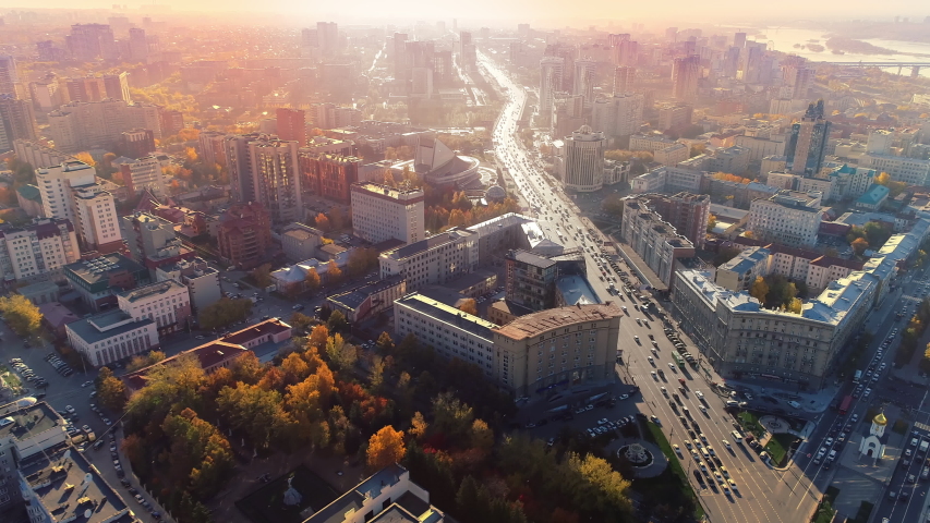 Road in the city center at dawn. Epic aerial flight over the morning city. Beautiful view. Early morning sunrise. Colorful autumn trees. Golden hour of sunset. Glory Inspiration. European city center Royalty-Free Stock Footage #1054578347