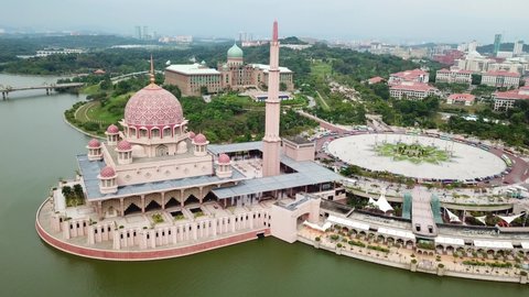 Putrajaya, Malaysia. Aerial view of the Putra Mosque, surrounded by Putrajaya Lake and tropical trees.