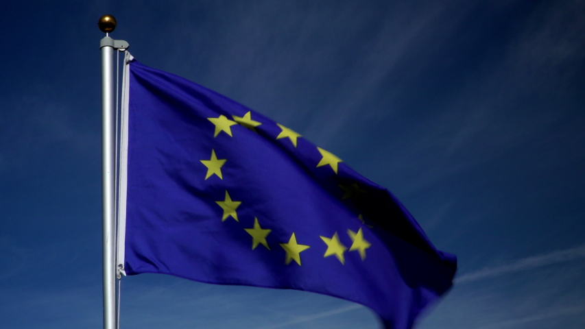 European Union Flag flying in the wind outdoors with Blue sky behind -  flag on flagpole. Stock 4K Video Clip Footage Royalty-Free Stock Footage #1054583690