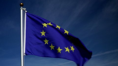 European Union Flag flying in the wind outdoors with Blue sky behind -  flag on flagpole. Stock 4K Video Clip Footage