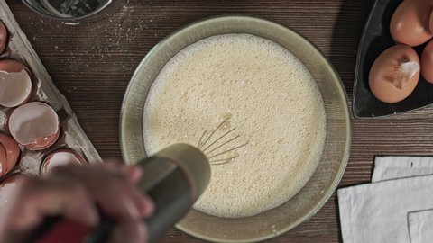 Kneading the dough. The process of making a delicious treat or dessert. Ingredients for baking on the table. Top plan for chef cook. Home cooking with care for relatives.