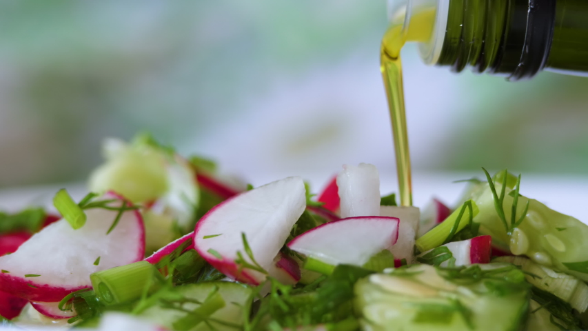 Vegetable Fresh Salad Food Healthy Meal Mediterranean Kitchen Vegetarian Diet Olive Oil. Closeup Pour Olive Oil on Fresh Salad. Close up Healthy Lunch, Colorful Food Onion Cucumber Radish. Slow Motion Royalty-Free Stock Footage #1054588523