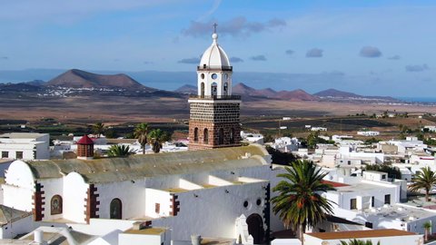 Spain, Canary Islands, Lanzarote - CIRCA 2020: Teguise, Church of Our Lady of Guadalupe and Volcanic mountain landscape