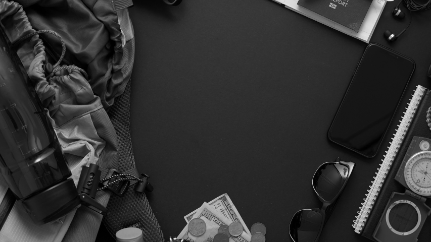 Travel and Tourist concept. Vacation and travel accessories placed on black background. With map, camera, passport, money, backpack, smartphone. Flat lay composition. Top view with copy space