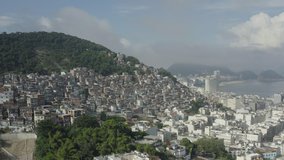 Drone flying towards the hills of Rio de Janeiro covered with slums in Brazil