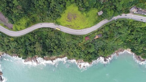 Top down view of curves of coastal road. Highway and freeway road. Beach seascape. Beach life landscape. Brazilian roads. Beach summer scene. Coastal road. Beach scene. Freeway and highway coast road