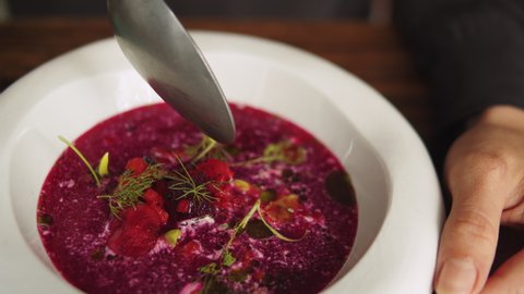 Traditional Ukrainian Russian borscht soup with white beans on the bowl. Plate of red beetroot soup borsch, Traditional Ukraine food high gourmet haute cuisine by chef