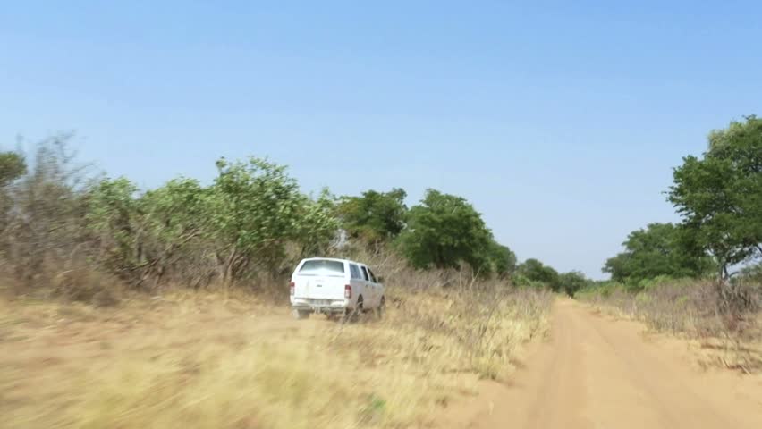car riving on main road road to Okavango in Botswana with offroad vehicle