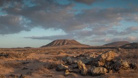 Looping gif video of clouds moving in sky above desert landscape in Fuerteventura, Spain