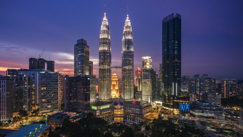 Kuala Lumpur, Malaysia - April 25: Dusk to night time lapse view overlooking Kuala Lumpur City Centre and national landmark Petronas Twin Towers in Kuala Lumpur, Malaysia. 