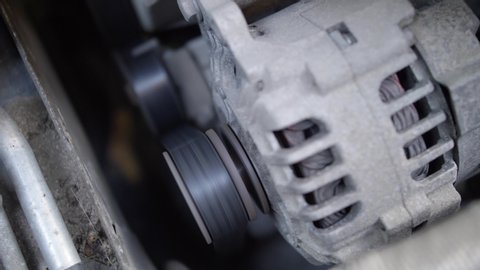 Car's Engine Fan Belt and Alternator Under the Hood