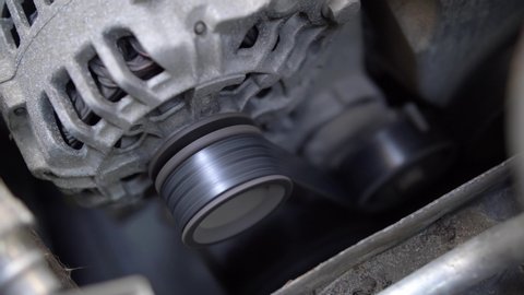 Car's Engine Fan Belt and Alternator Under the Hood