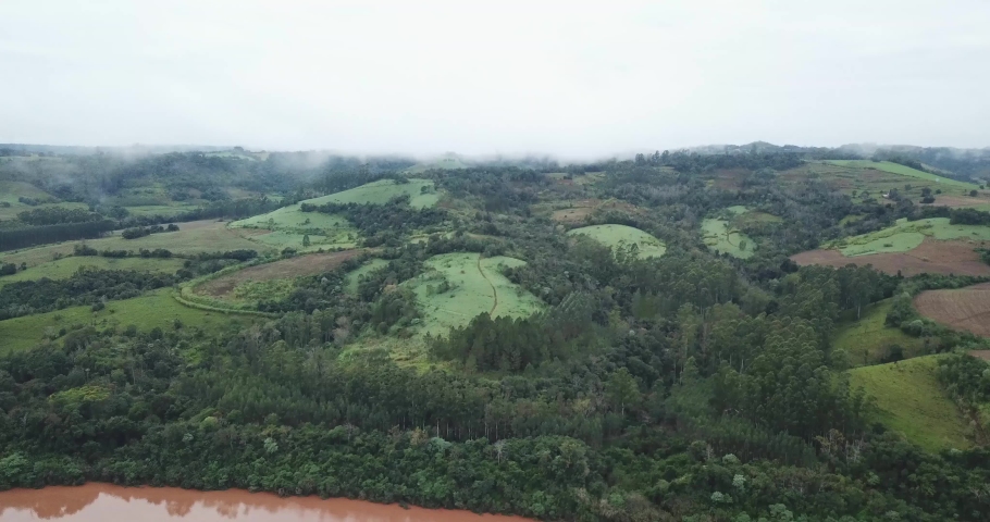 Air view of a beautiful and sad landscape with a los of fauna and trees in Misiones Argentina, with humidity clouds over it.