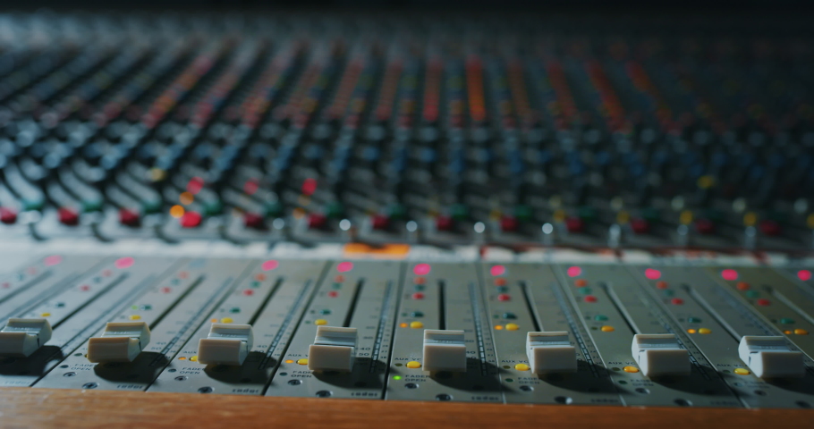 Macro slide shot of a sound producer hand is using a music mixer with editing tools in a professional recording studio. | Shutterstock HD Video #1054635227