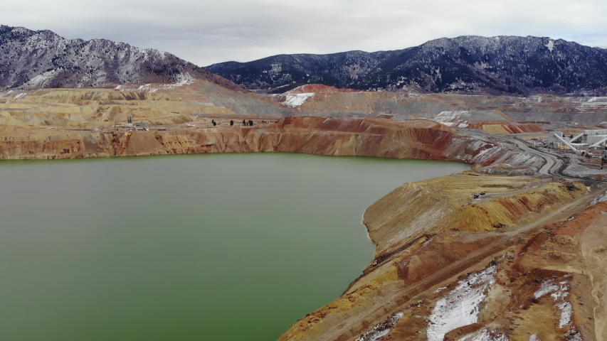 Montana USA aerial shot. Drone flight on the road that goes to the mountains in autumn, where you can see the yellow and orange rocks, the relief and landscape of the mountains, the snow-capped mounta