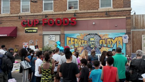 Minneapolis , MN / United States - 06 03 2020: A crowd pays tribute to George Floyd in front of iconic Minneapolis mural