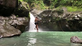 Romantic couple holding hands and jumps into the waterfall on summer day. - Powered by Shutterstock - Get 15% off with code: PIKWIZARD15