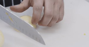 Man chef slicing onion for vegetarian lunch, vegan lifestyle, close up