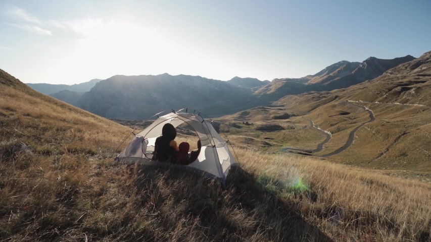 People inside the tent. on a mountainside in Montenegro mooving camera