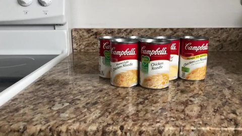 Cans of campbell's soup on counter slo-mo videoin kitchen. Saint Augustine, Florida USA. June 20, 2020.