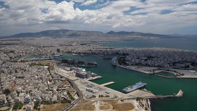 Aerial drone rotational video of famous port of Piraeus where passenger ferries travel to popular Aegean destinations as seen from high altitude, Attica, Greece