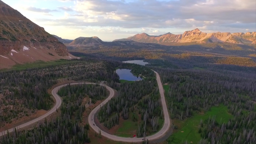 Dramatic aerial drone shot of the large S curve on the Mirror Lake Highway. Near Bald Mountain Pass overlooking Hayden Peak and the Uinta Mountains in Northern Utah, United States.