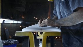 Surfboard manufacturing, Shaper cutting down the stringer on a surfboard. Concept of small business owner, skilled professional, occupation & job in America.  - Powered by Shutterstock - Get 15% off with code: PIKWIZARD15