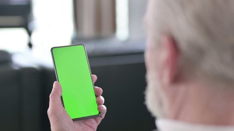 Rear View of Senior old Businessman using Smartphone with Chroma Screen