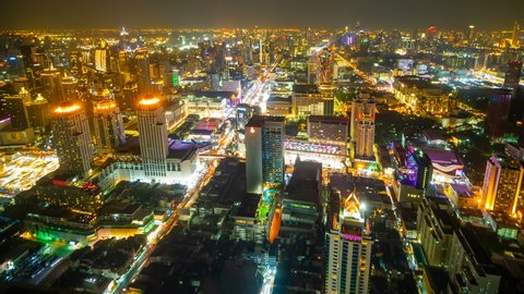 time lapse aerial view of Bangkok city downtown and road traffic at night of Thailand , Cityscape