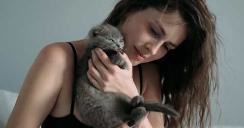 Beautiful Young Adult Girl Playing with Her Little Scottish Fold Cat