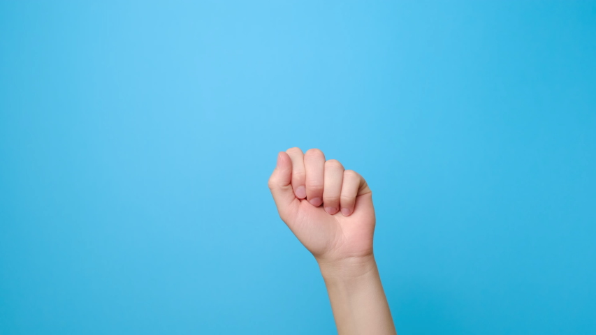 Finger signal. Close up of female hand showing no, isolated on blue studio background with copy space for advertisement. Disapproving gesture. Advertising area, mock up. | Shutterstock HD Video #1054675868
