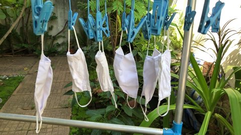 Self made cloth mask hanging dry on the clothes line. As new normal life during Corona Virus outbreak. COVID-19