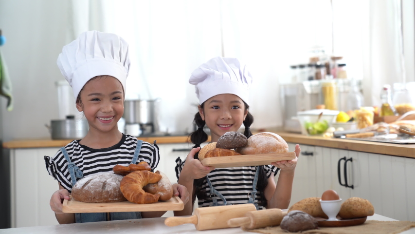 kids happy and fun are preparing the dough, make bread in the kitchen. Royalty-Free Stock Footage #1054682096