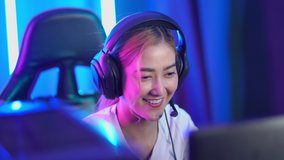 Portrait of the Young woman Pro Gamer Playing in Online Video Game and talks with Team Players through Microphone headset video 4K resolution
